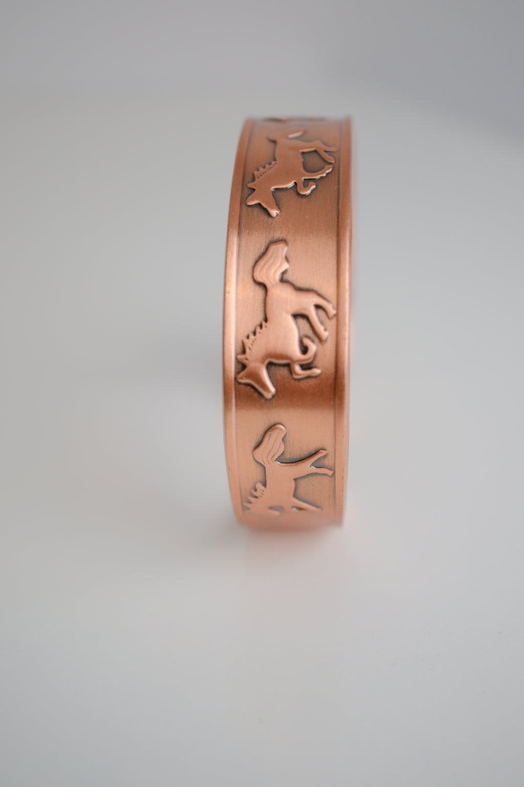 Copper cuff bracelet with engraved horse design