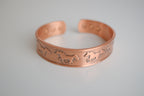 Copper cuff bracelet with engraved horse design
