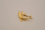 Gold-tone double dolphin brooch