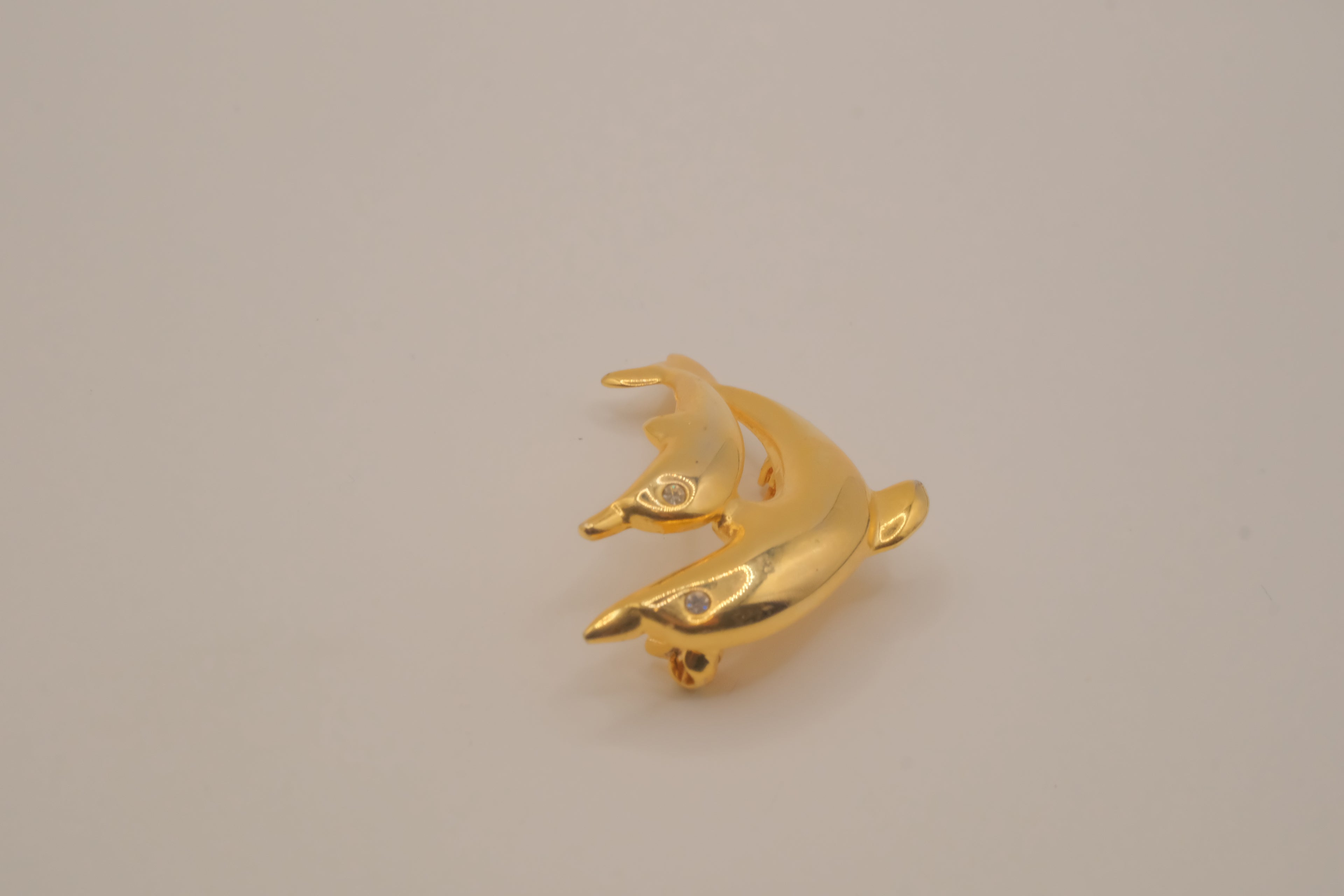Gold-tone double dolphin brooch