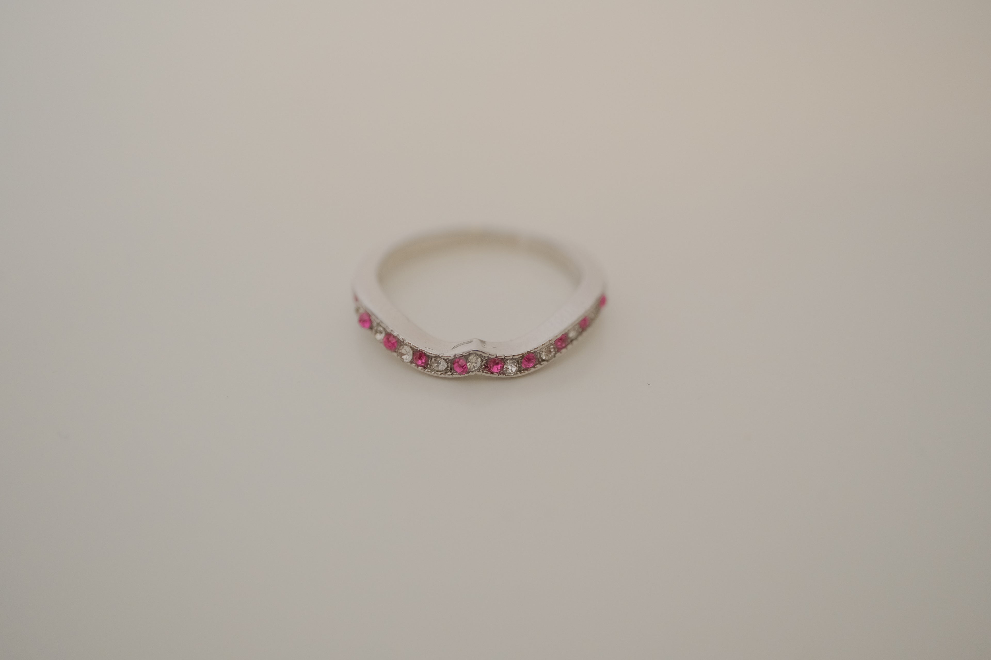 Silver tone pink and white curved "wishbone" ring