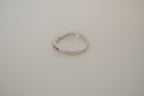 Silver tone pink and white curved "wishbone" ring