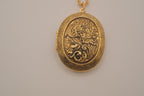 Vintage oval gold locket necklace with  Raised floral design