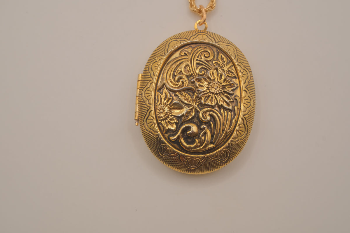 Vintage oval gold locket necklace with  Raised floral design