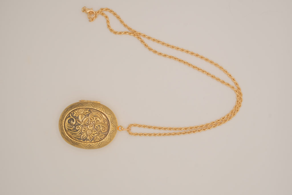 Vintage oval gold locket necklace with  Raised floral design