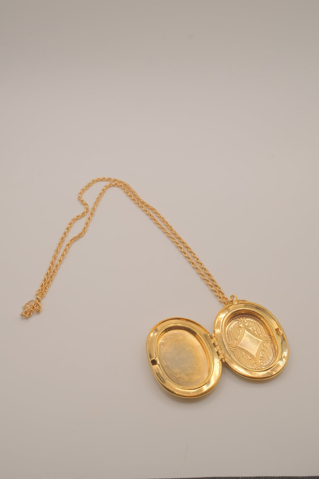 Vintage oval gold locket necklace with  Raised floral design