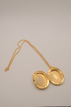 Vintage oval gold locket necklace with  Raised floral design