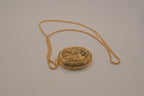 Vintage oval gold locket necklace with  Raised floral design