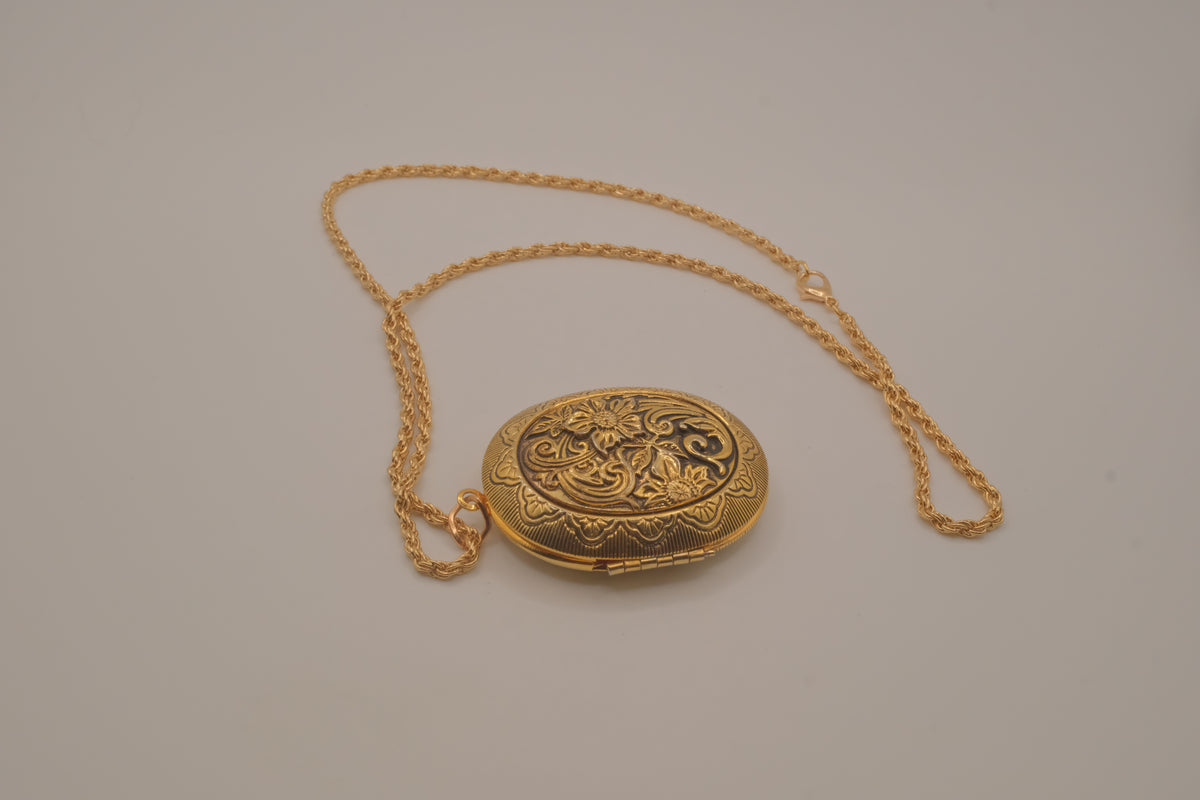 Vintage oval gold locket necklace with  Raised floral design