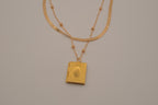 Layered Sleek and beaded chain with gold book locket pendant