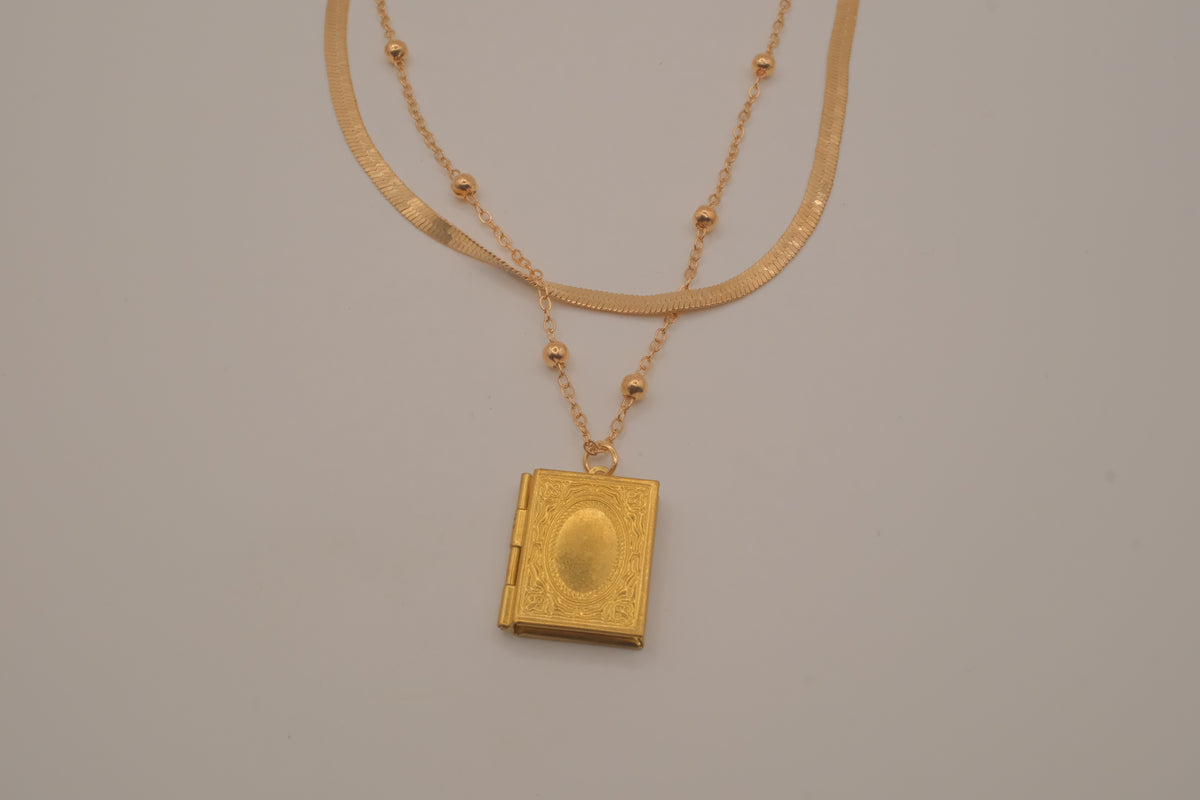Layered Sleek and beaded chain with gold book locket pendant