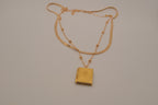 Layered Sleek and beaded chain with gold book locket pendant