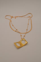 Layered Sleek and beaded chain with gold book locket pendant