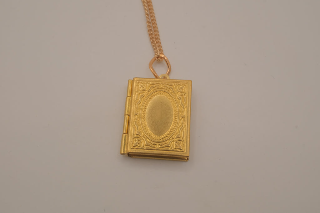 Vintage-style gold book locket pendant on gold link chain