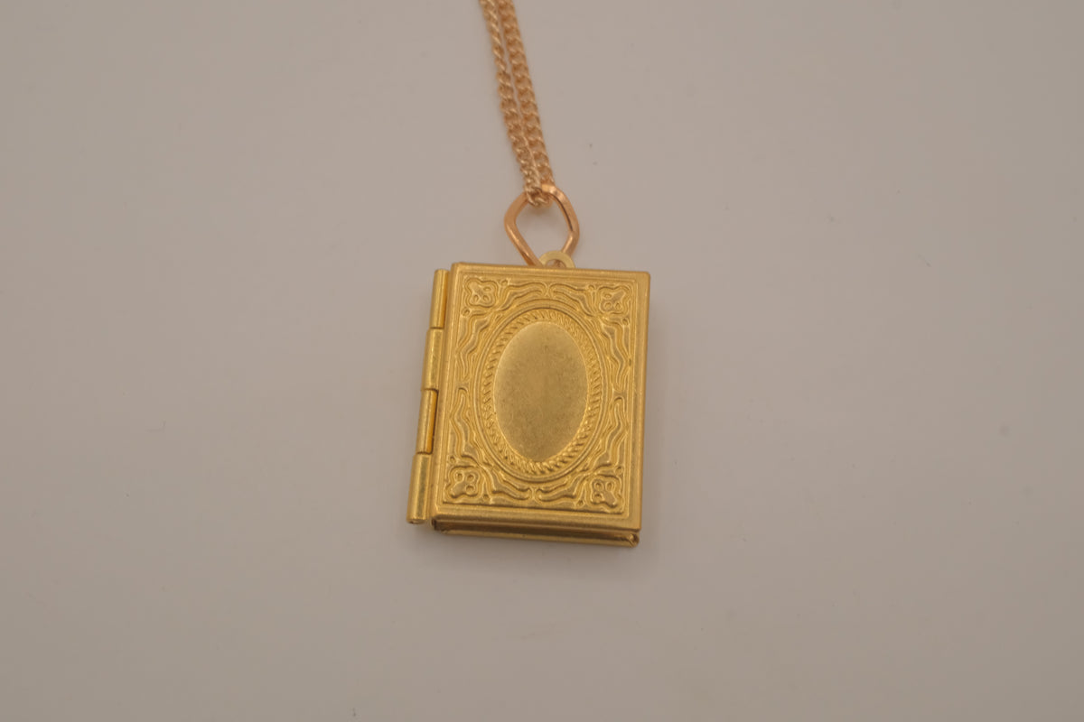 Vintage-style gold book locket pendant on gold link chain