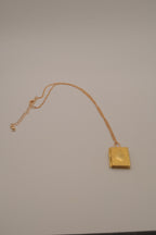 Vintage-style gold book locket pendant on gold link chain