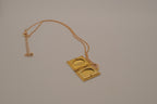 Vintage-style gold book locket pendant on gold link chain