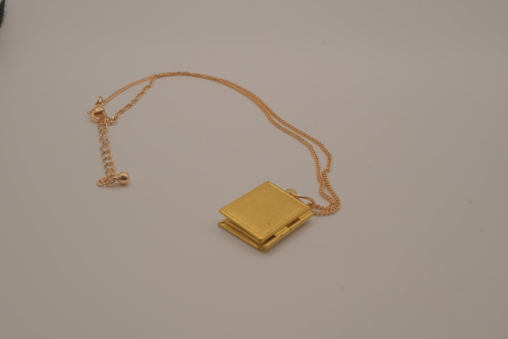 Vintage-style gold book locket pendant on gold link chain