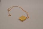 Vintage-style gold book locket pendant on gold link chain
