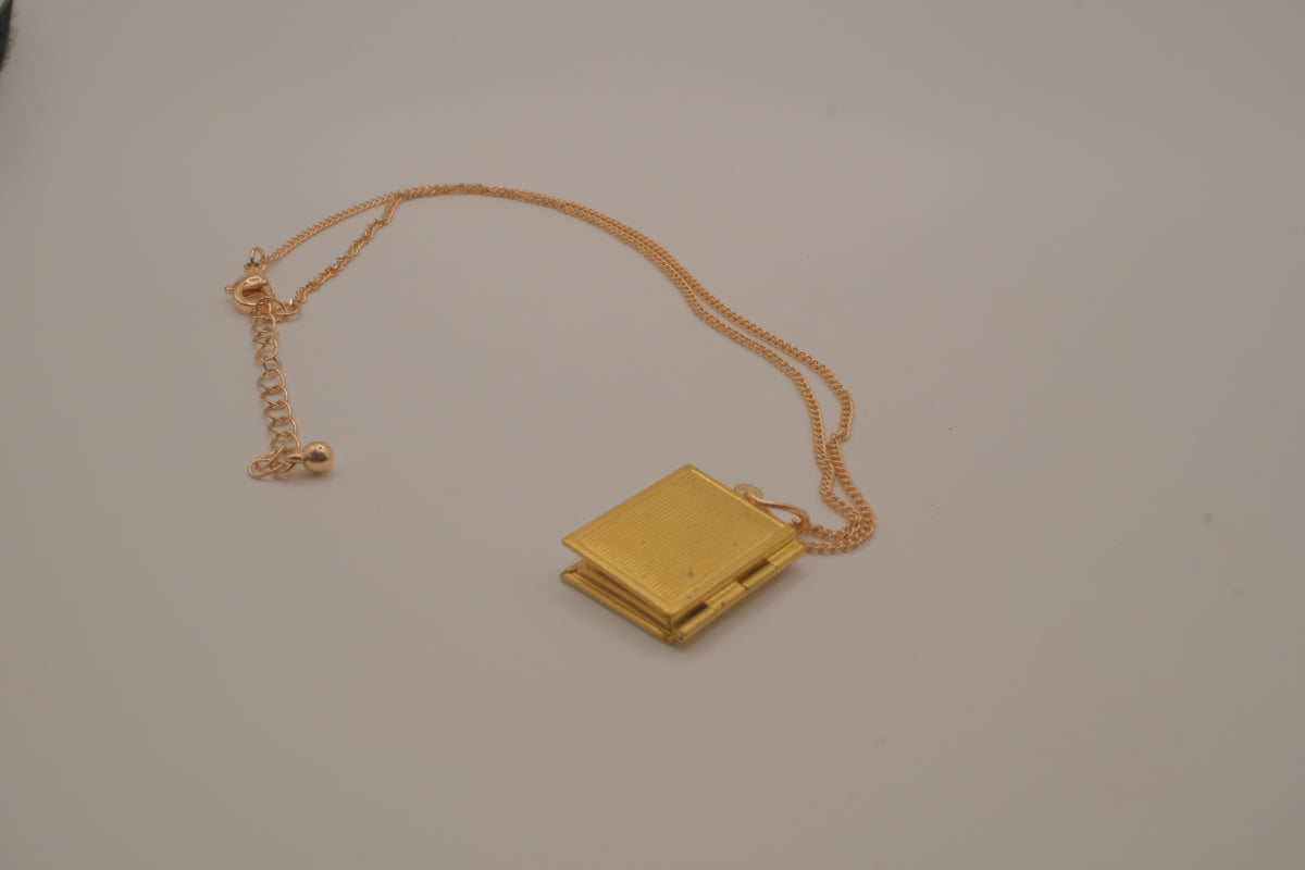 Vintage-style gold book locket pendant on gold link chain