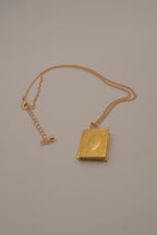 Vintage-style gold book locket pendant on gold link chain