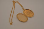 Vintage Victorian-style oval gold locket pendant