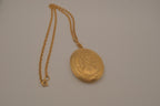 Vintage Victorian-style oval gold locket pendant