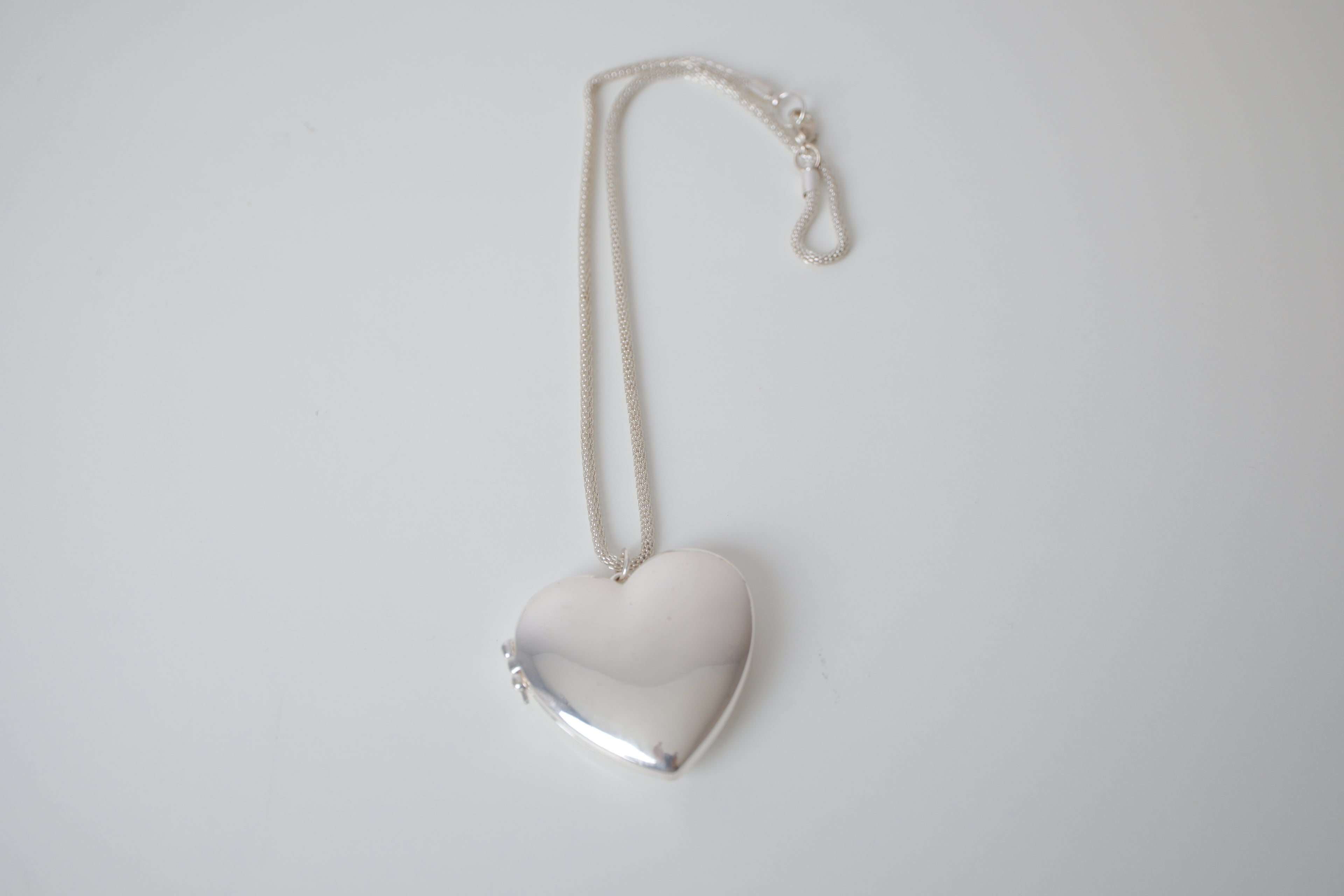 Polished silver heart locket necklace