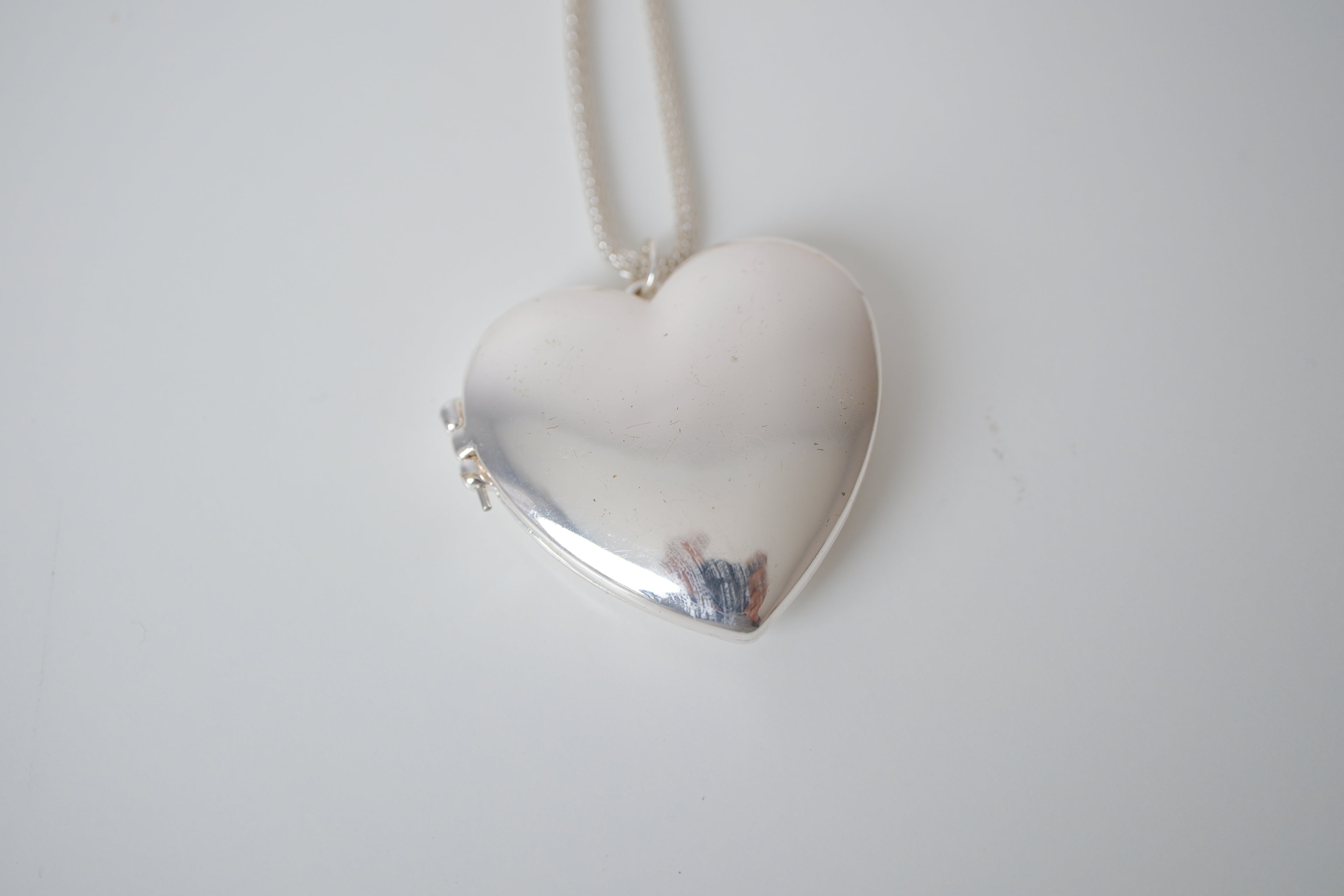 Polished silver heart locket necklace