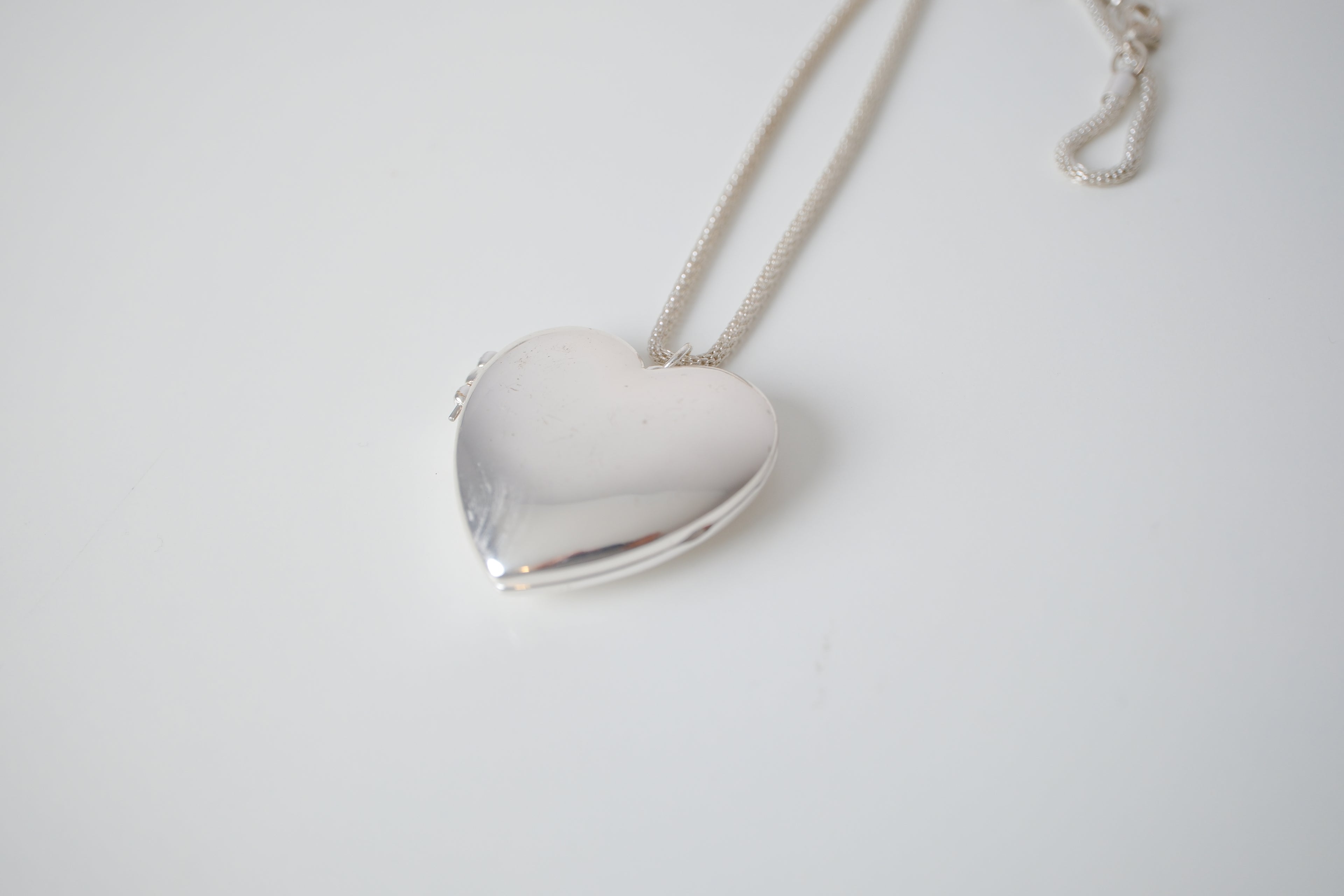 Polished silver heart locket necklace