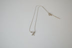 Silver toned Kiss pendant necklace