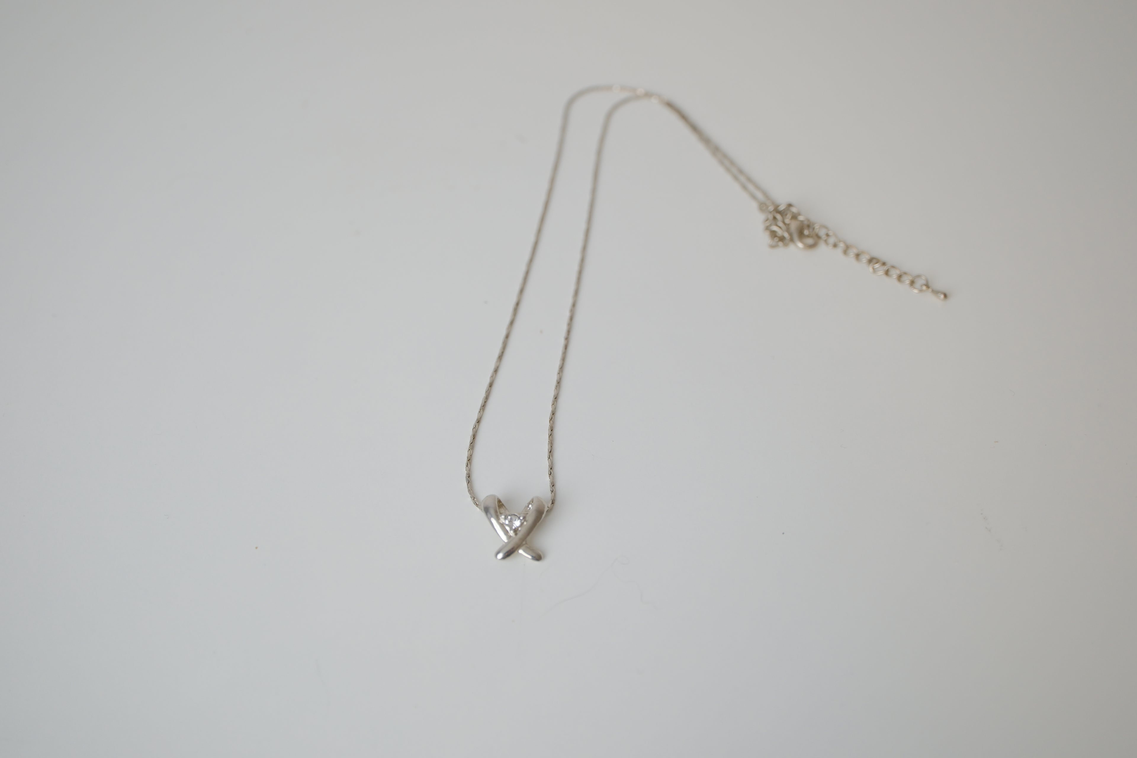 Silver toned Kiss pendant necklace