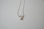 Silver toned Kiss pendant necklace