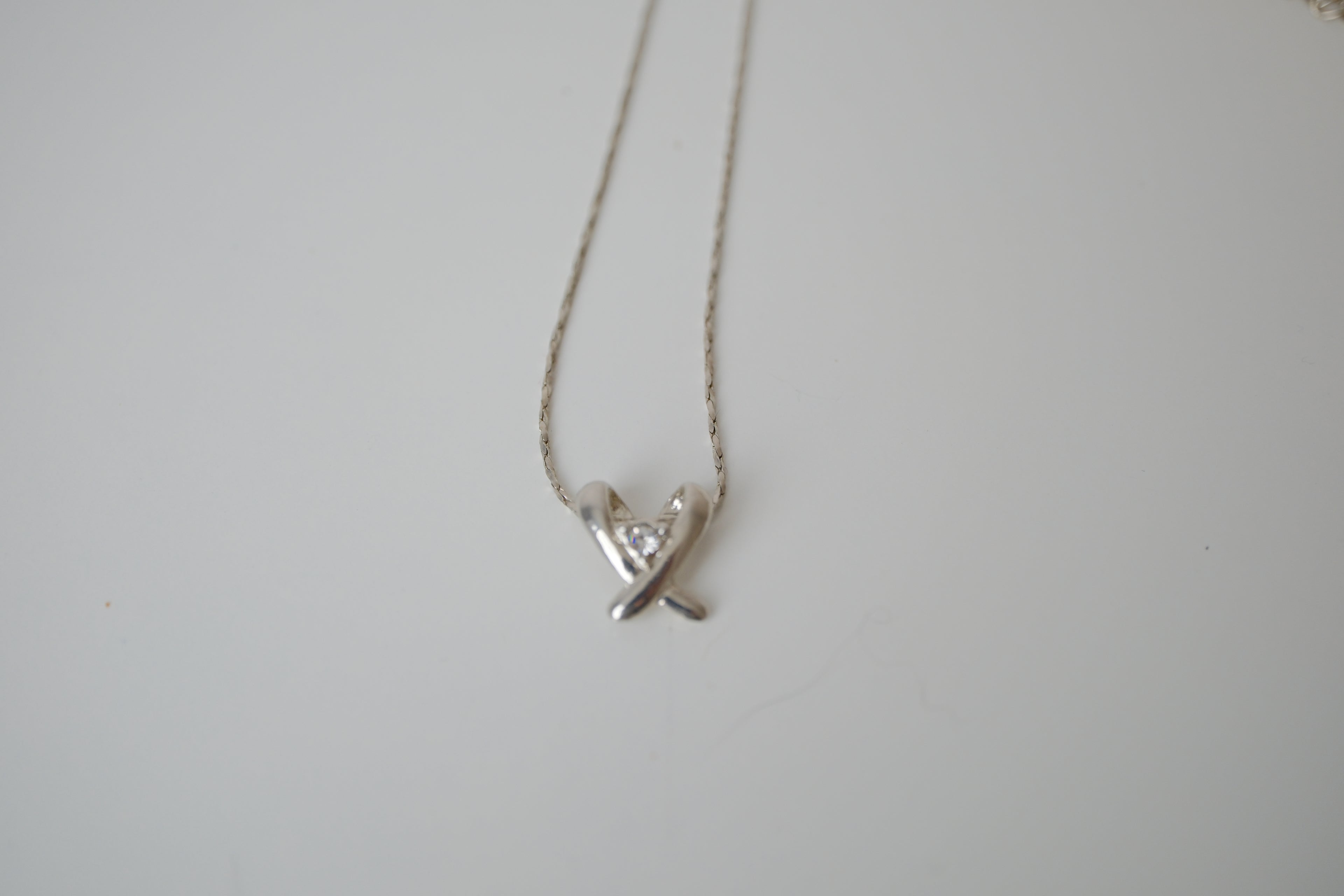 Silver toned Kiss pendant necklace