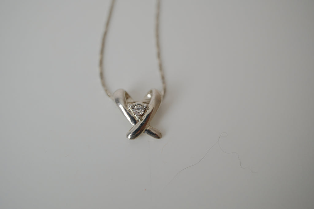 Silver toned Kiss pendant necklace