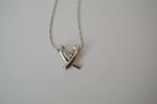 Silver toned Kiss pendant necklace