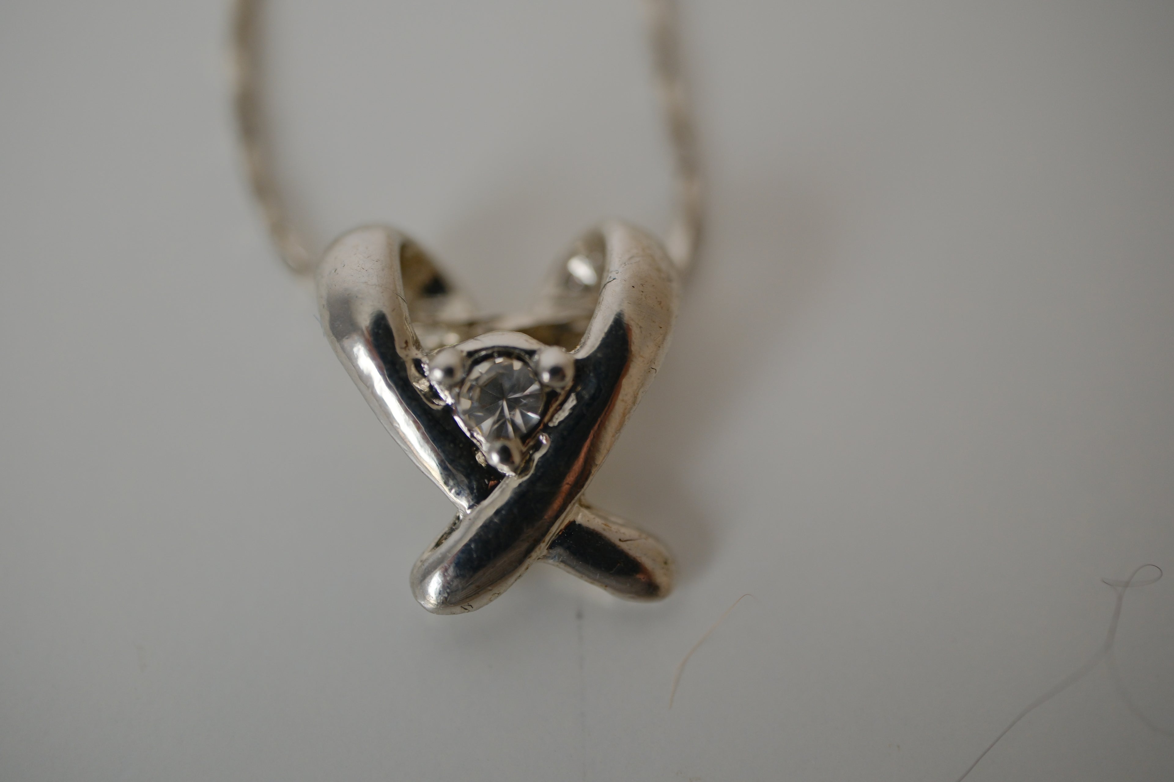 Silver toned Kiss pendant necklace