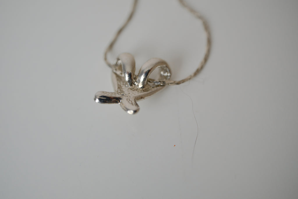 Silver toned Kiss pendant necklace