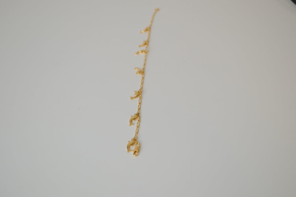 Gold tone dolphin charm bracelet