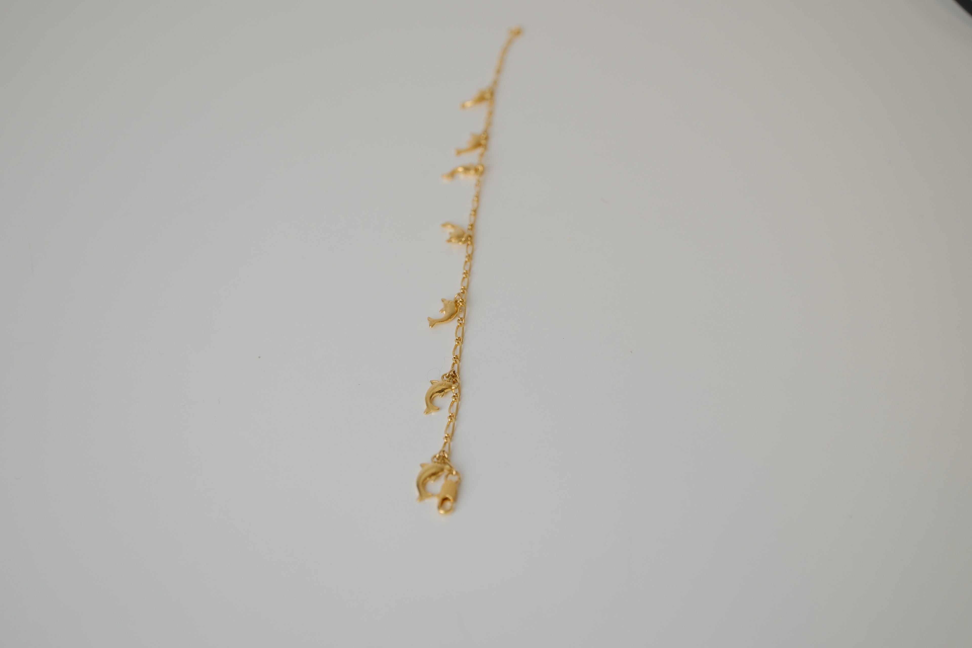 Gold tone dolphin charm bracelet