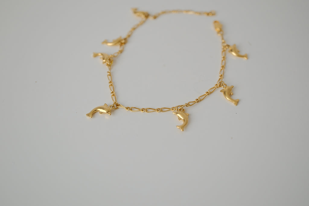 Gold tone dolphin charm bracelet