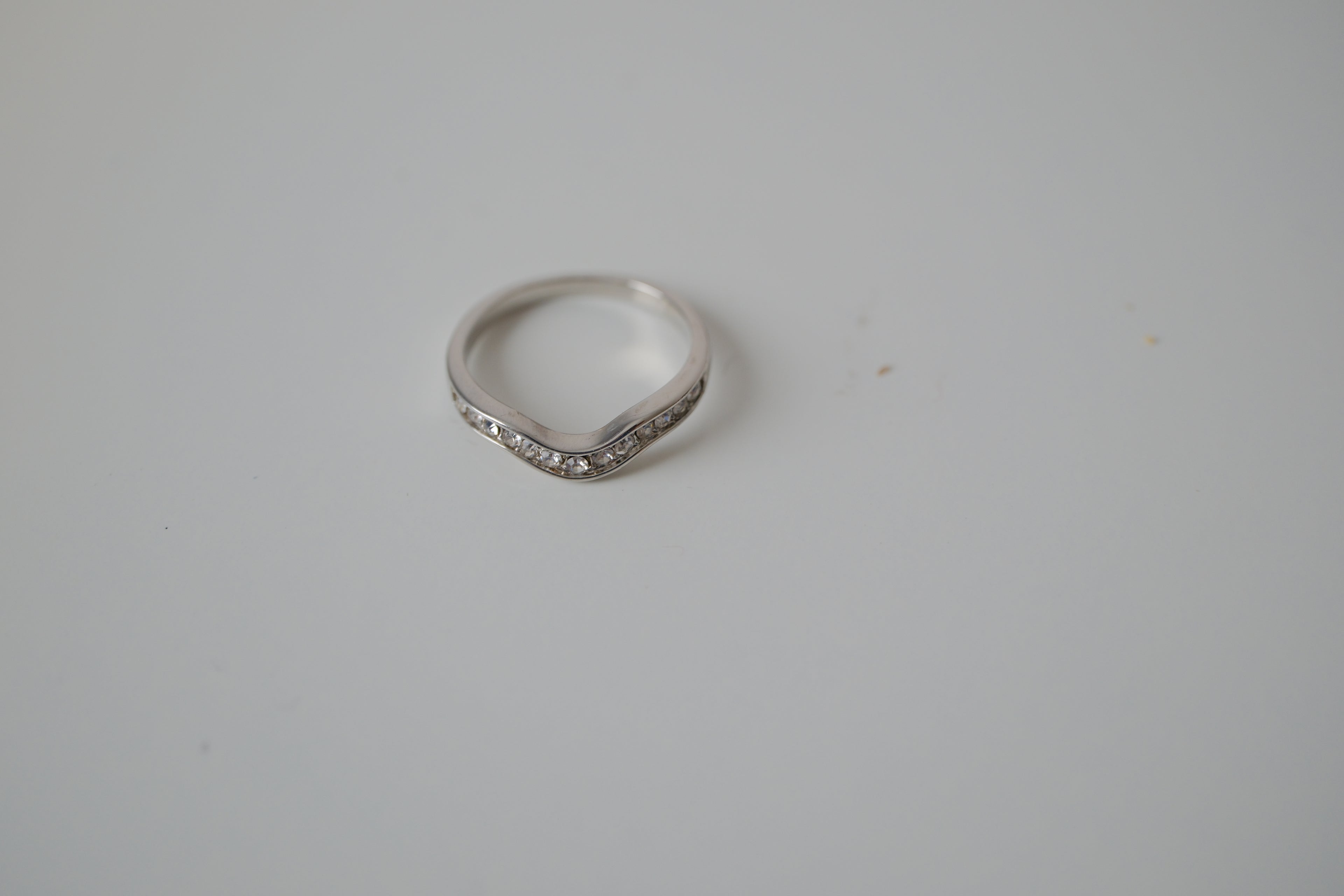 Silver tone white stone curved "wishbone" ring