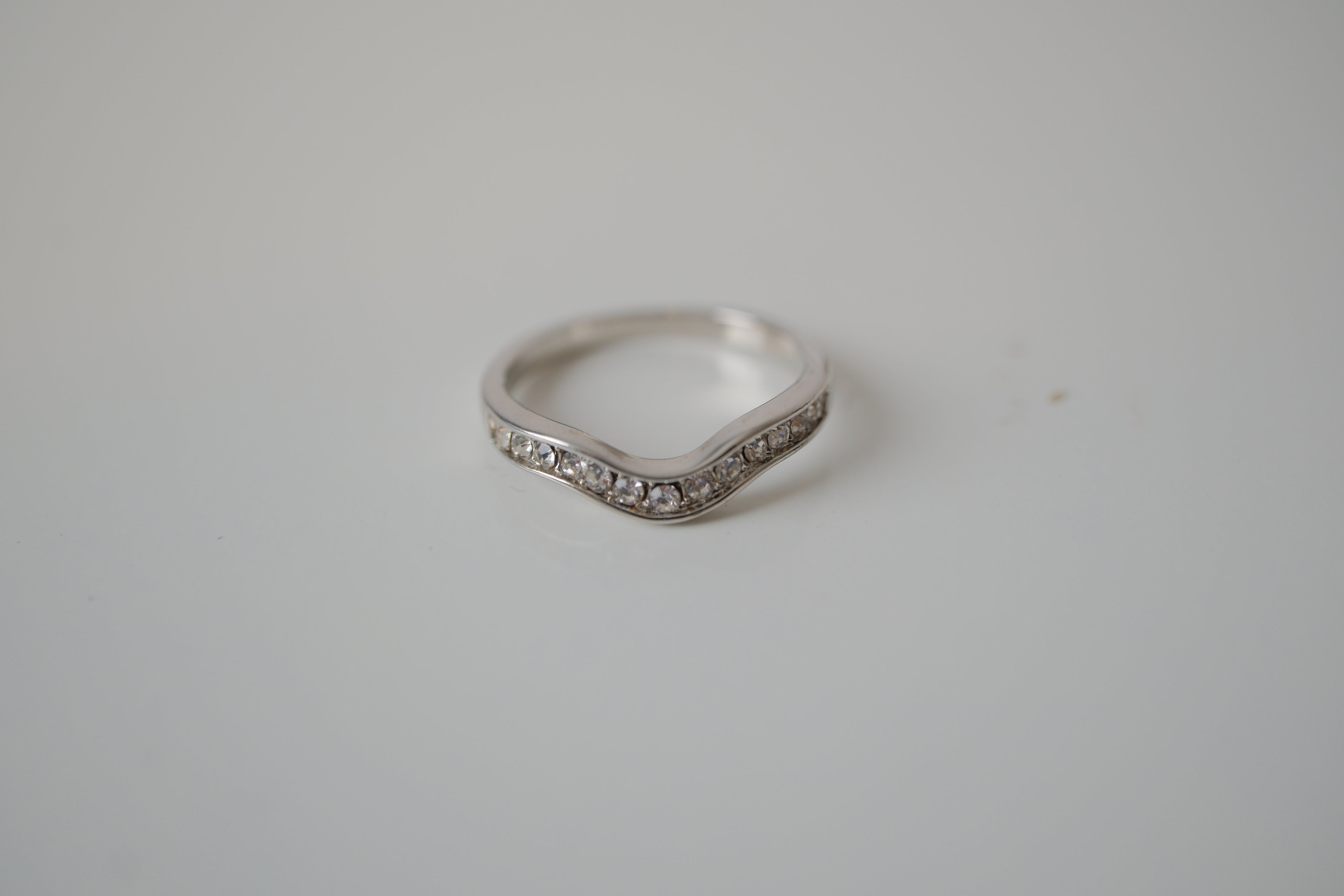 Silver tone white stone curved "wishbone" ring