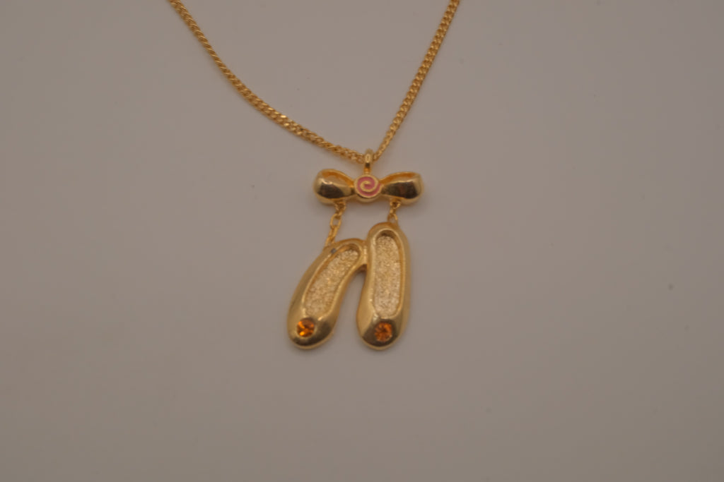Gold toned ballet slipper pendant necklace