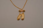 Gold toned ballet slipper pendant necklace
