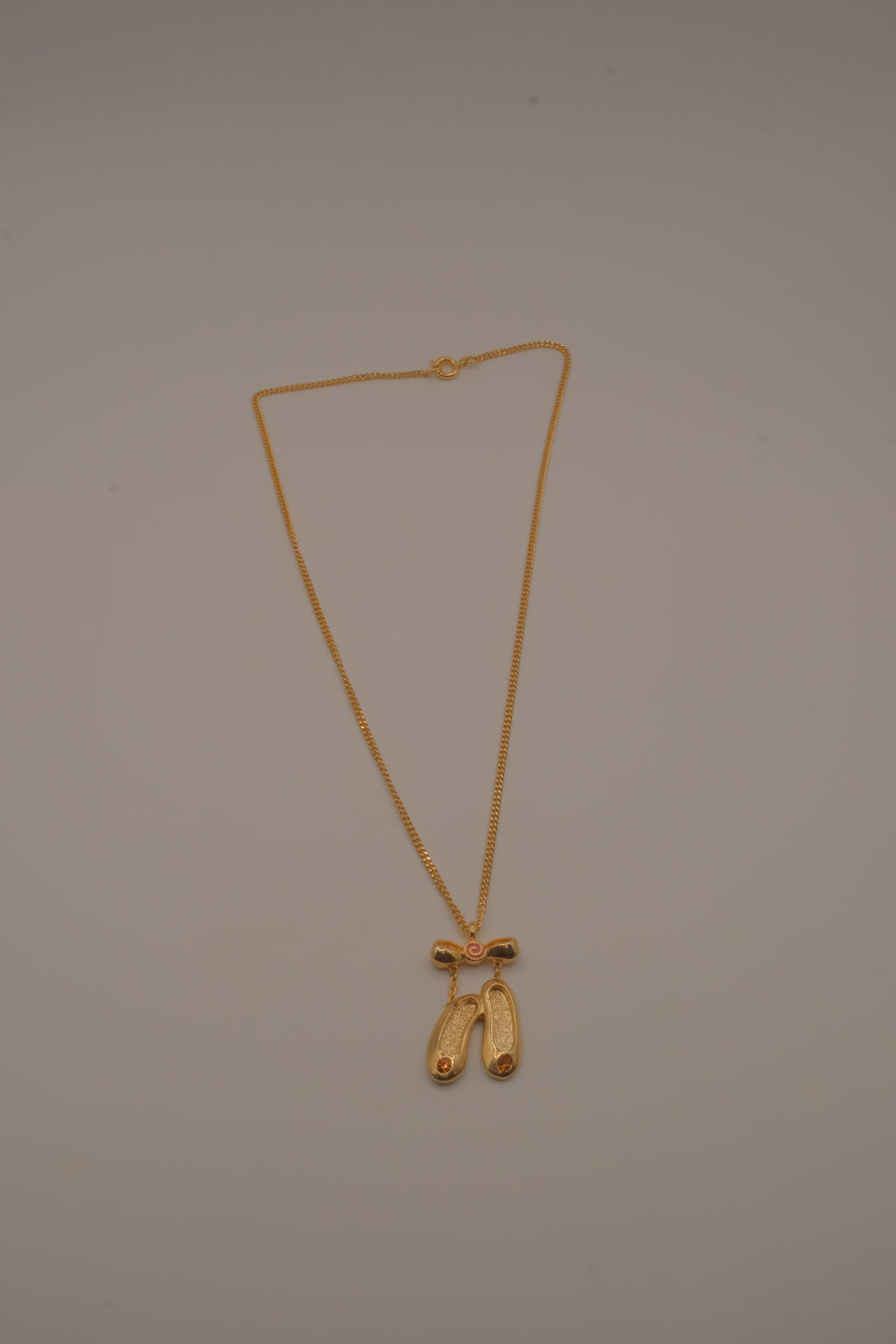 Gold toned ballet slipper pendant necklace