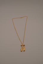 Gold toned ballet slipper pendant necklace