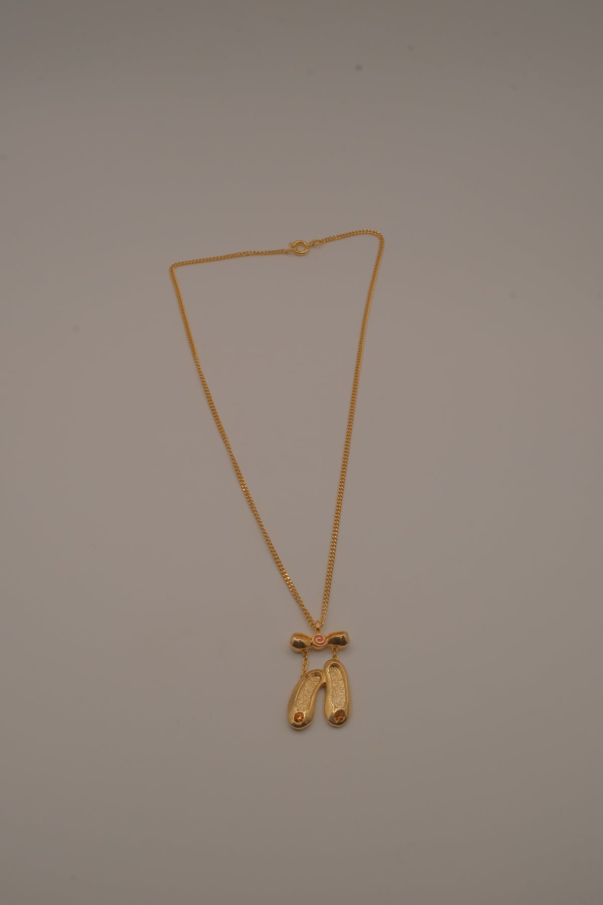 Gold toned ballet slipper pendant necklace