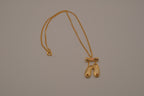 Gold toned ballet slipper pendant necklace