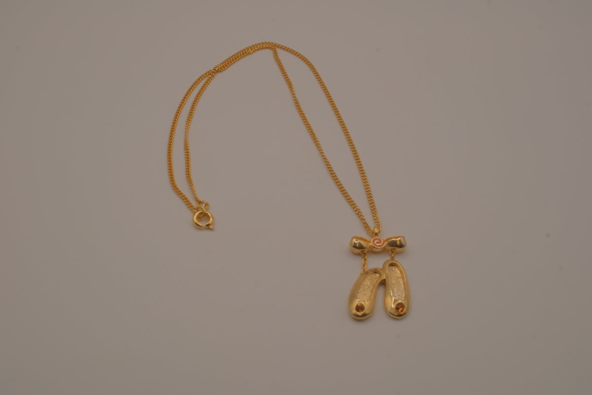 Gold toned ballet slipper pendant necklace